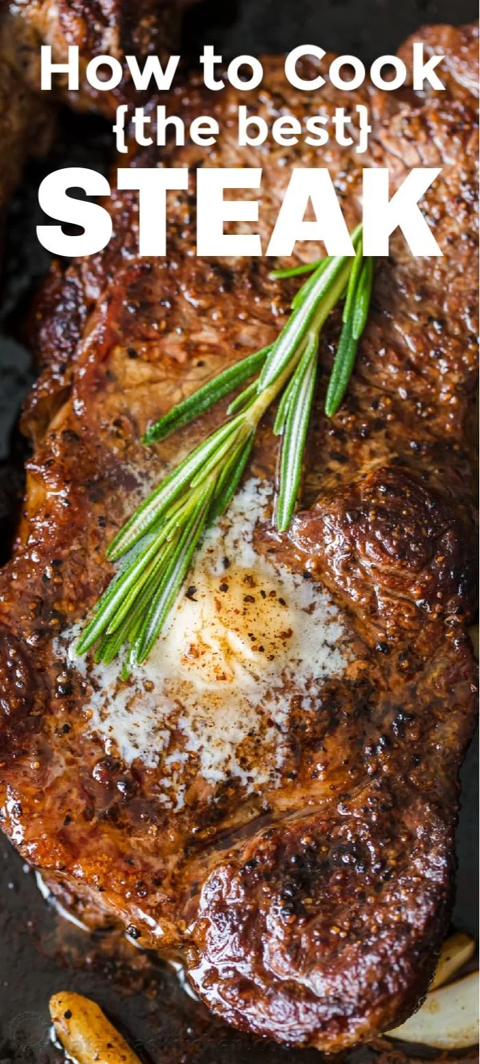 Perfectly pan-seared steak on a plate with herbs and spices.