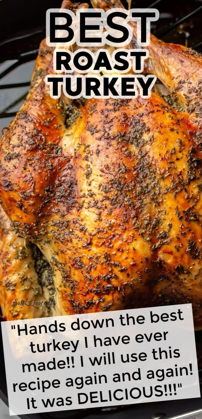 Golden roast turkey on a platter garnished with herbs and vegetables