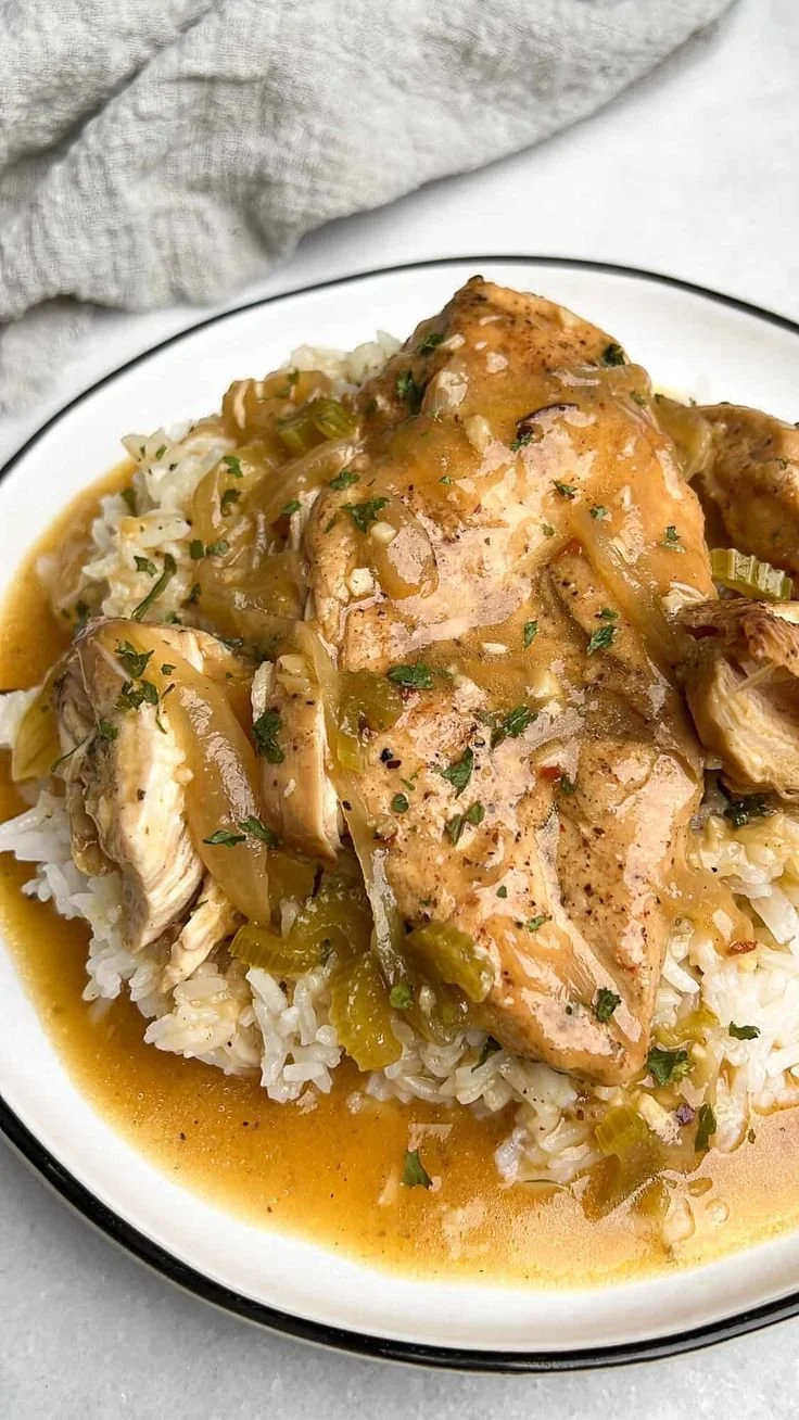 Delicious slow cooker smothered chicken served with gravy and sides