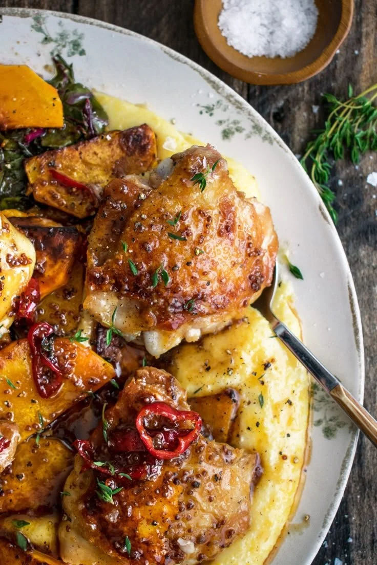 Spicy Maple Mustard Chicken served with creamy polenta on a plate