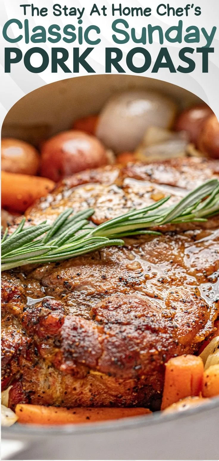 Juicy Sunday pork roast garnished with herbs, served with vegetables.