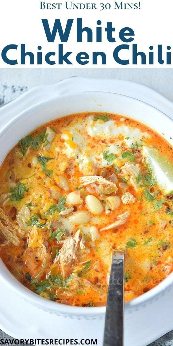 Bowl of creamy white chicken chili garnished with cilantro and lime