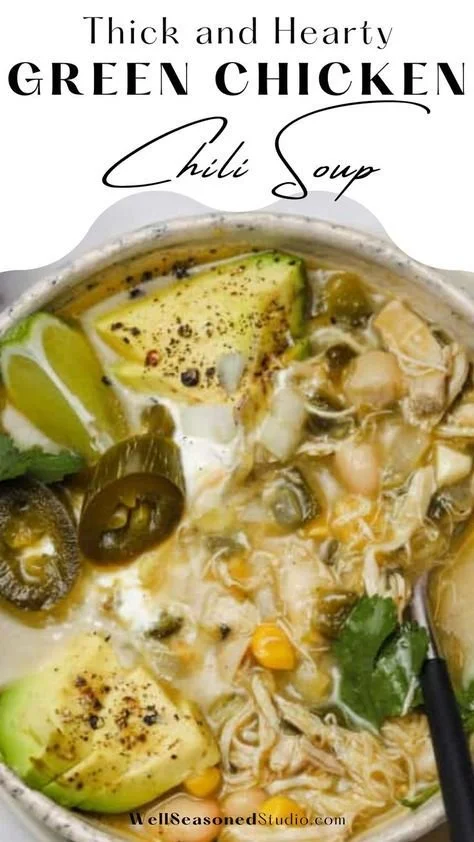 Bowl of cozy green chicken chili garnished with cilantro and lime