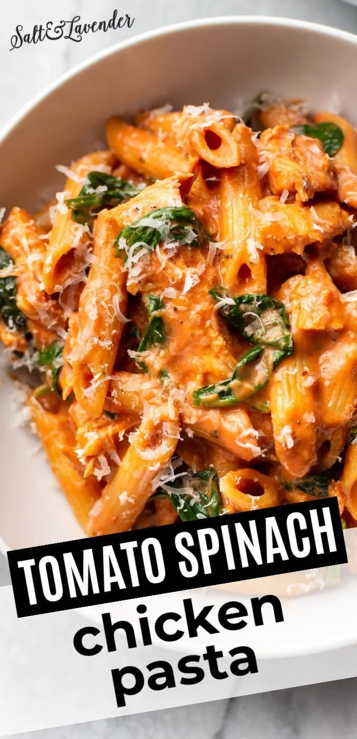 Bowl of Tomato Spinach Chicken Pasta with fresh ingredients